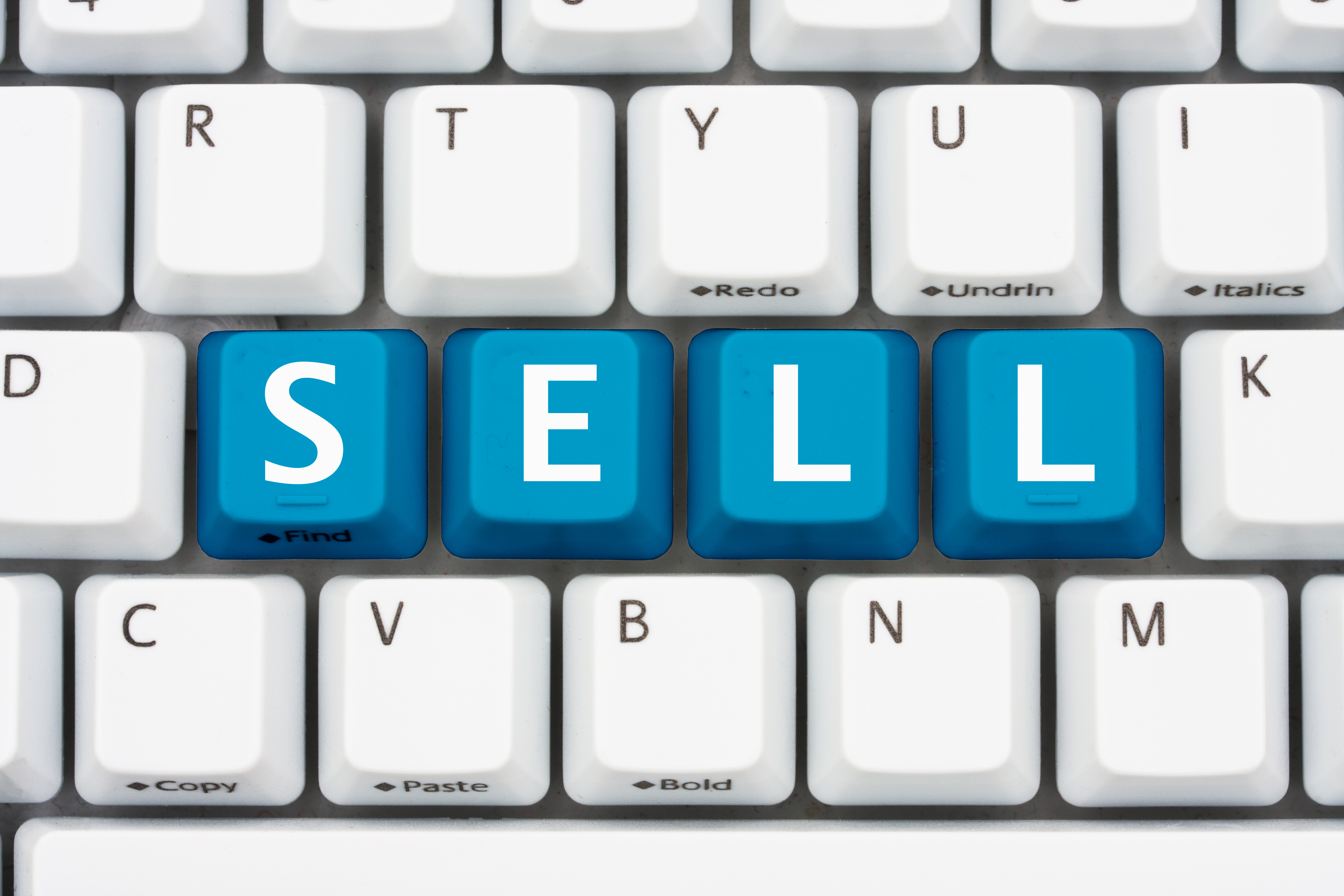 A computer keyboard with blue keys spelling Sell, Selling on the internet