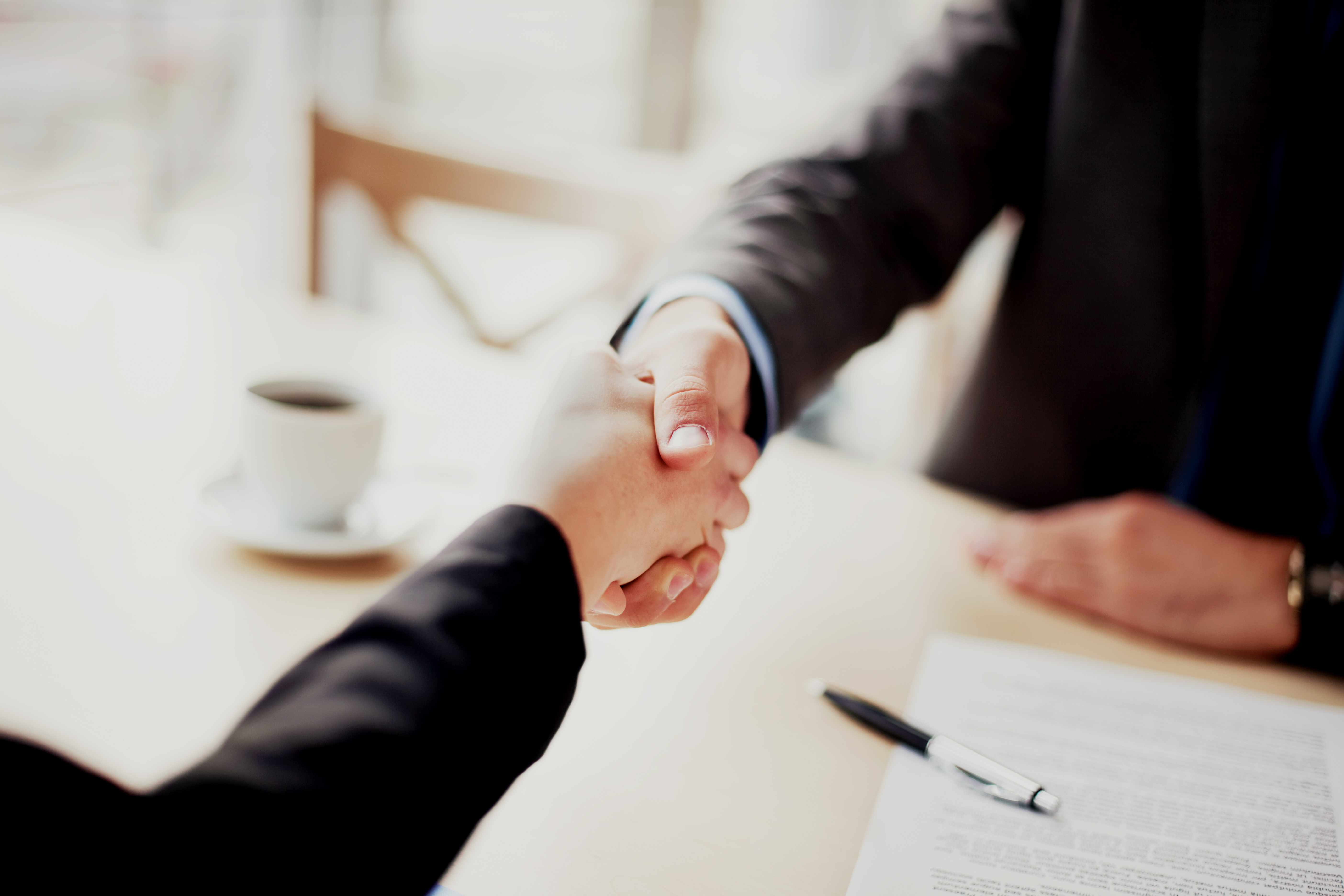 Handshake closeup of businesswoman and businessman.