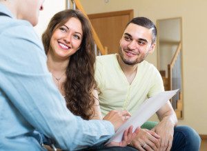 Young couple signing up for Life Insurance